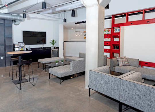 a living room with couches and a table and a kitchen at Tyler Street Stacks, Minneapolis Minnesota