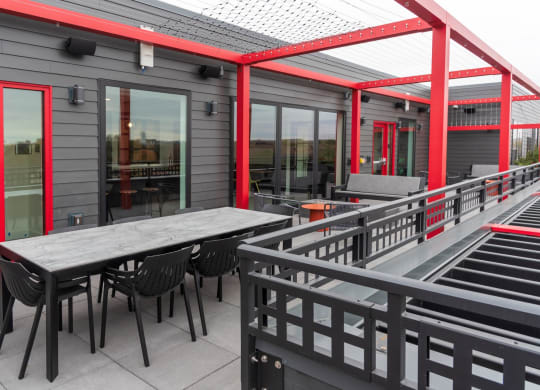 a patio with tables and chairs outside of a building at Tyler Street Stacks, Minneapolis