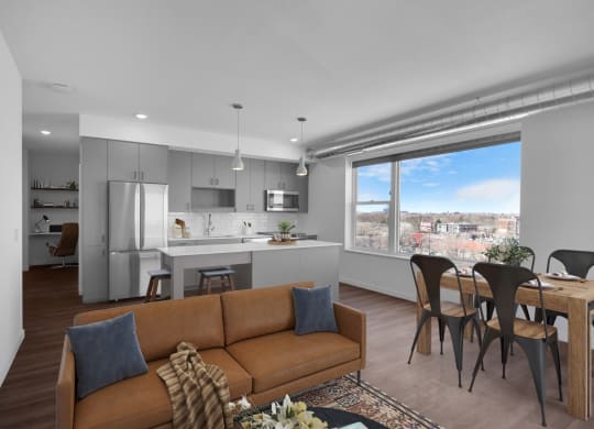an open living room with a kitchen and a large window at Tyler Street Stacks, Minneapolis, 55413