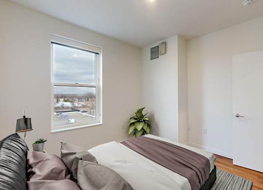 Bedroom With Expansive Windows at Tyler Street Stacks, Minneapolis, MN