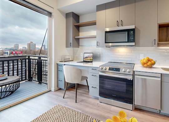 A modern kitchen with a view of the city.at Tyler Street Stacks, Minneapolis, MN 55413