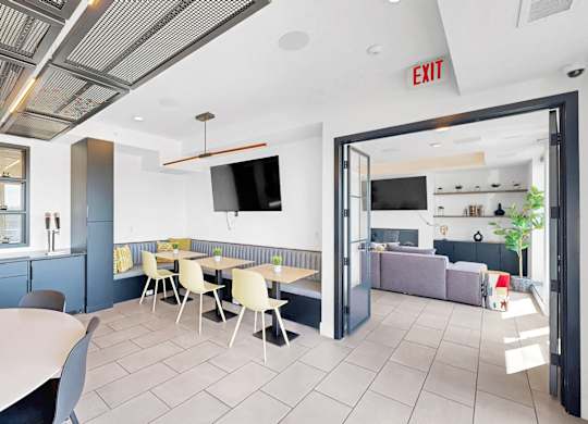 A modern dining area with a white table and chairs.