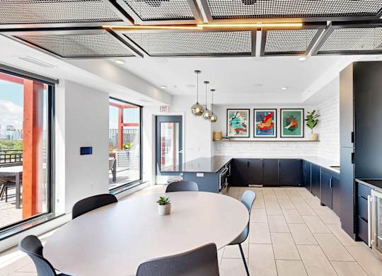 A modern dining area with a table and chairs.