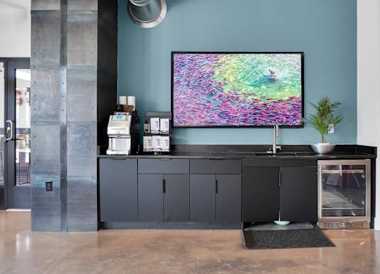 A modern living room with a large TV displaying a colorful abstract image.