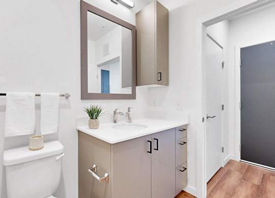 A white toilet sits next to a sink in a small bathroom.