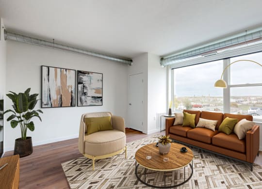 a living room with a couch and a large window at Tyler Street Stacks, Minnesota, 55413
