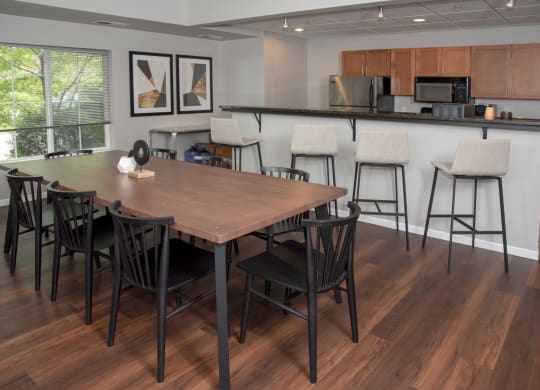 UPI community room with table seating and kitchen at Urban Park I and II Apartments, Minnesota