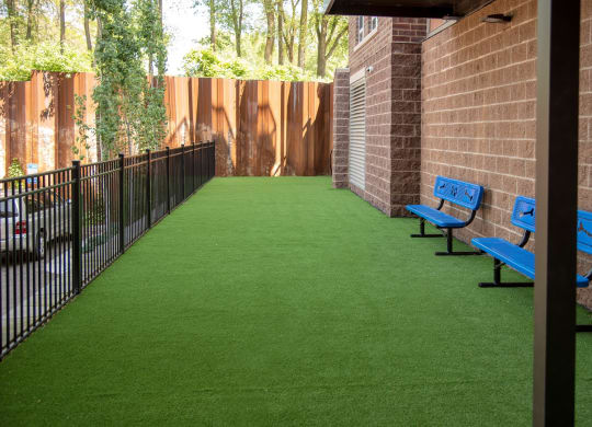 Outdoor dog run with artificial turf and benches at Victoria Flat, Victoria, MN