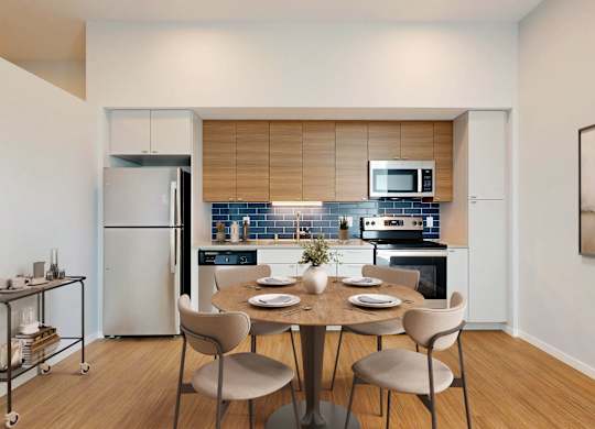 A modern kitchen with a dining table set for four.