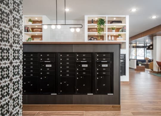 a view of the mail room with a large collection of mailboxes