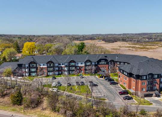A large building with a parking lot in front of it.