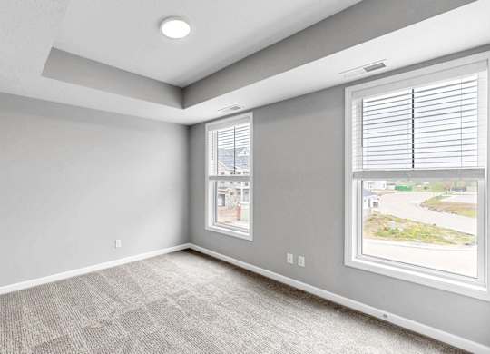 A room with a window showing a view of a street.