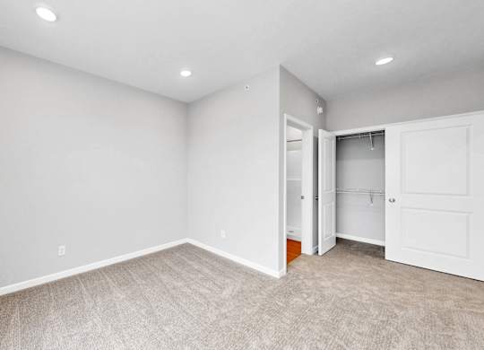 A room with a carpeted floor and white walls.
