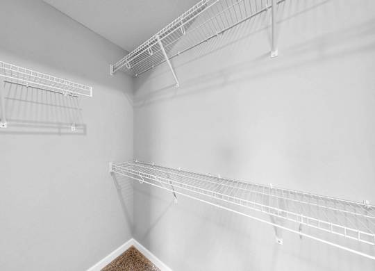 Empty white shelves in a room.