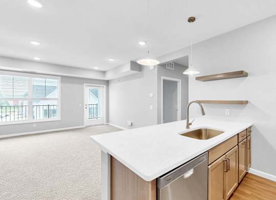 A kitchen with a white countertop and wooden cabinets.