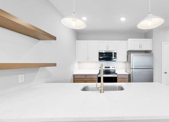 A modern kitchen with a large island in the center.