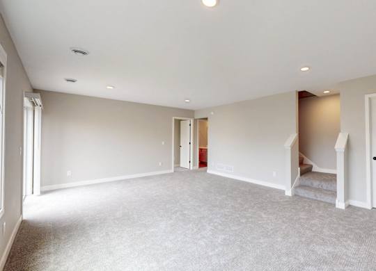 Carpeted bonus room with staircase and closet at Wildwood Lakeville Apartments, Lakeville, 55044