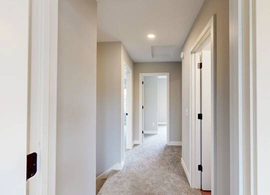 Upstairs hallway with carpeting and recessed lighting at Wildwood Lakeville Apartments, Lakeville, Minnesota