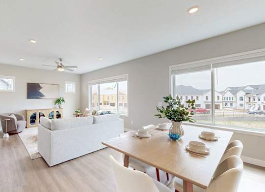 Open dining and living space with large windows at Wildwood Lakeville Apartments, Minnesota, 55044