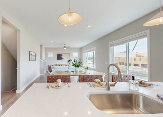 Kitchen island overlooking dining area with pendant light at Wildwood Lakeville Apartments, Lakeville, 55044