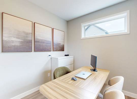 Home office with wood desk and wall art at Wildwood Lakeville Apartments, Minnesota, 55044