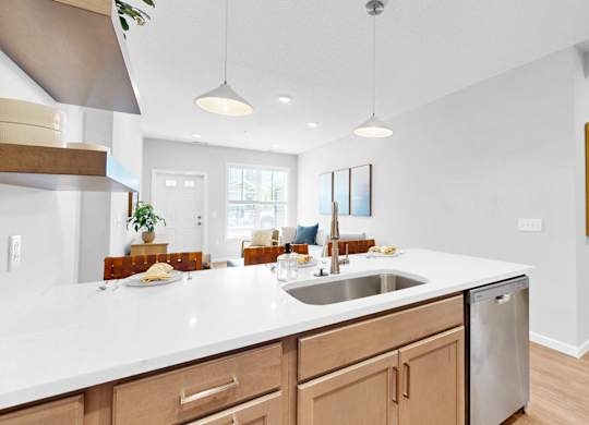 A modern kitchen with wooden cabinets and a white countertop.