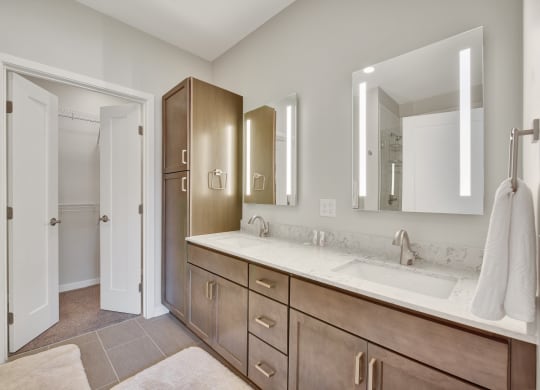 a bathroom with a large vanity with two sinks and two mirrors