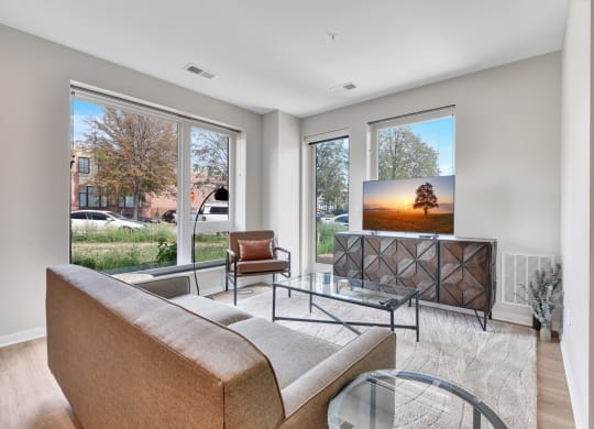 a living room with a tv on the wall and a couch in front of it