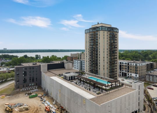a view of a tall building with a pool in front of it