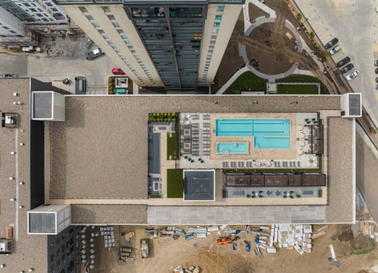 a view from above of a large building with a pool on top of it