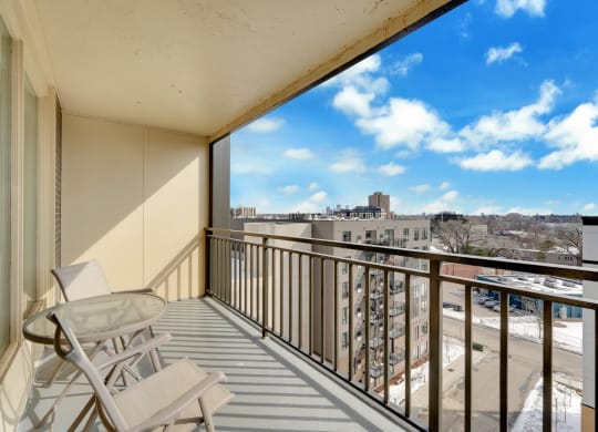 the view from the balcony of a condo with a glass table and chairs