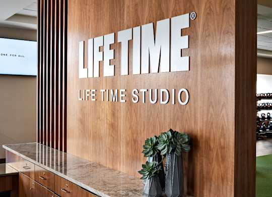 A wooden wall with the words at One West, New York, NY,10004