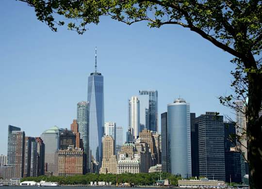 A city skyline with a tall building in the center at One West,  New York,10004
