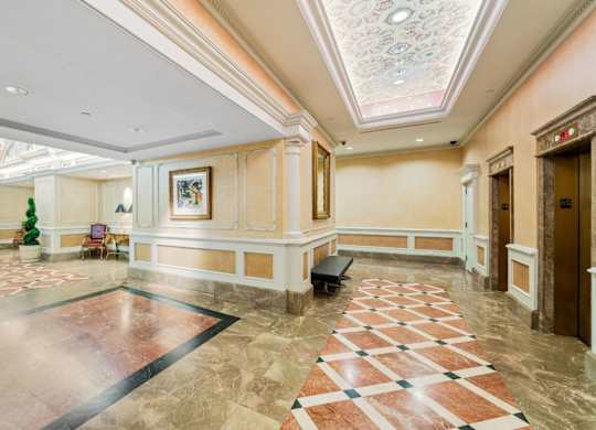 A large, well-lit lobby with a marble floor and a checkerboard pattern. at One West,New York, 10004