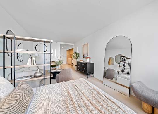 A bedroom with a bed, a dresser, and a mirror at One West,New York, NY