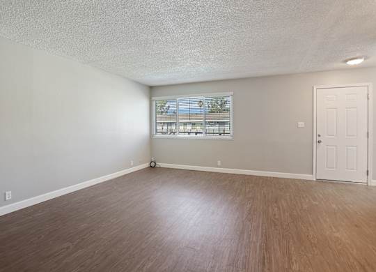 A room with a window and a door.