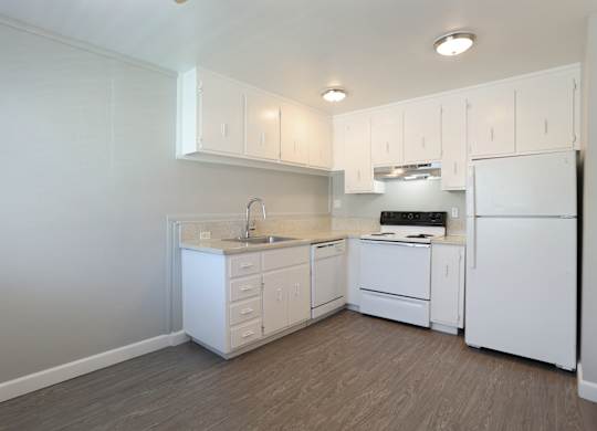 A kitchen with white appliances and cabinets.