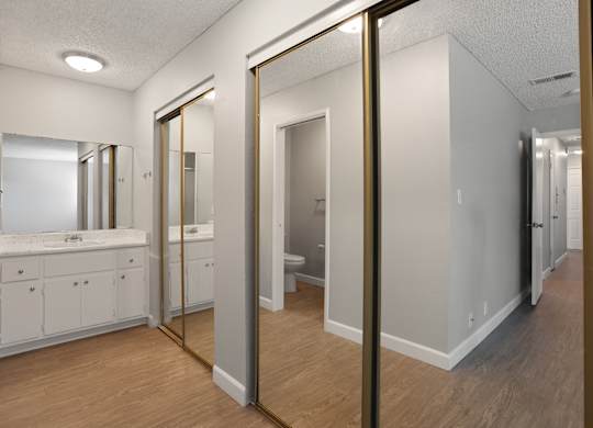 A bathroom with a vanity and a mirror.