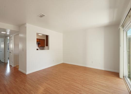 A room with wooden floors and white walls.