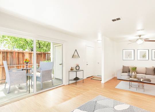 A modern living room with a glass table and chairs.