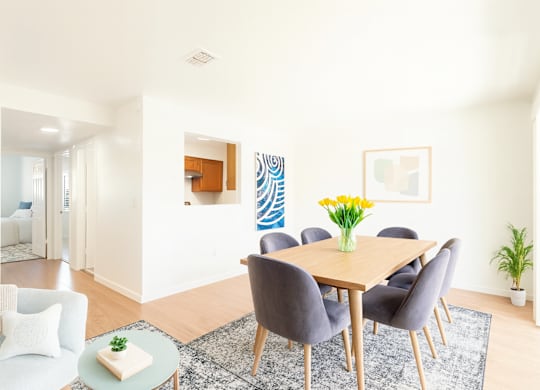 A dining room with a table set for six.