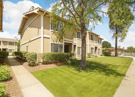 Apartment complex with a green lawn in front.