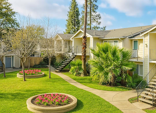 A residential area with houses and a flower bed.