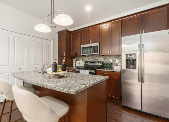 a kitchen with stainless steel appliances and a granite counter top