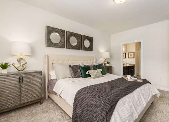 a bedroom with a bed and three mirrors on the wall