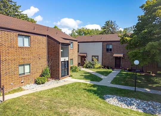 A sunny day at a residential area with houses and green lawns.