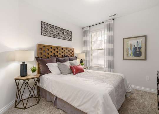 a bedroom with a large bed and a window
