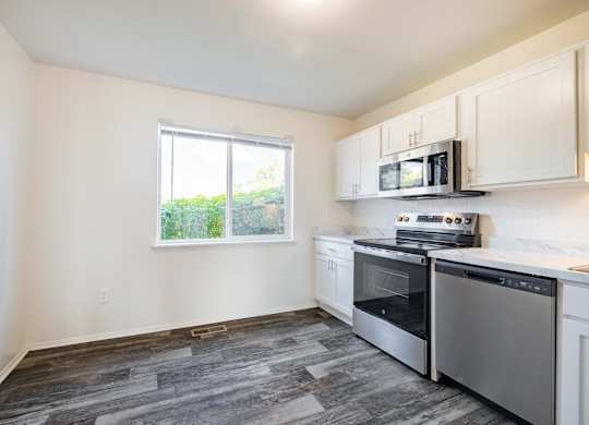 A kitchen with a stove top oven and microwave.