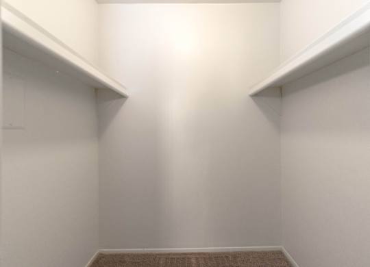 A small, empty room with a carpeted floor and white walls.