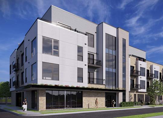 A modern building with a white and black exterior and large windows.